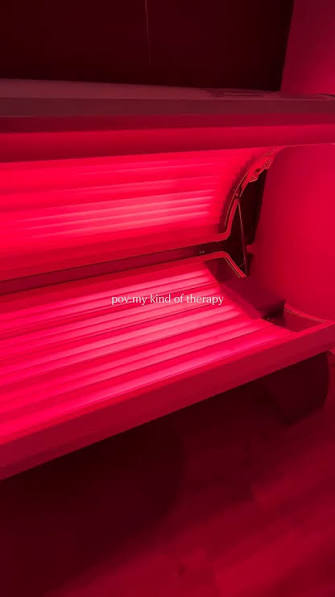Red light therapy bed glowing red at Next Level Spa